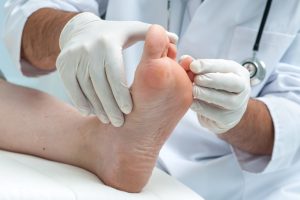 A person is getting their foot examined by a doctor.