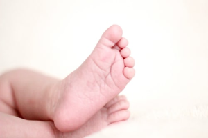 A baby 's foot is shown in the image.