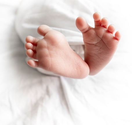 A baby 's feet are shown in the air.