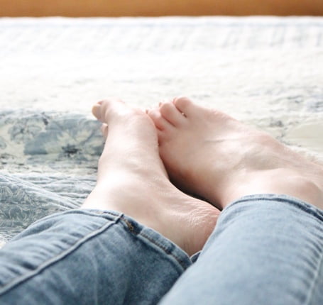 A person 's feet are shown on the ground.